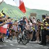 Romain Bardet entouré de ses supporters dans le virage "Magic Bardet" lors de la 11e étape du Tour de France, le 10 juillet 2024 au Pas de Peyrol. (MARCO BERTORELLO / AFP)