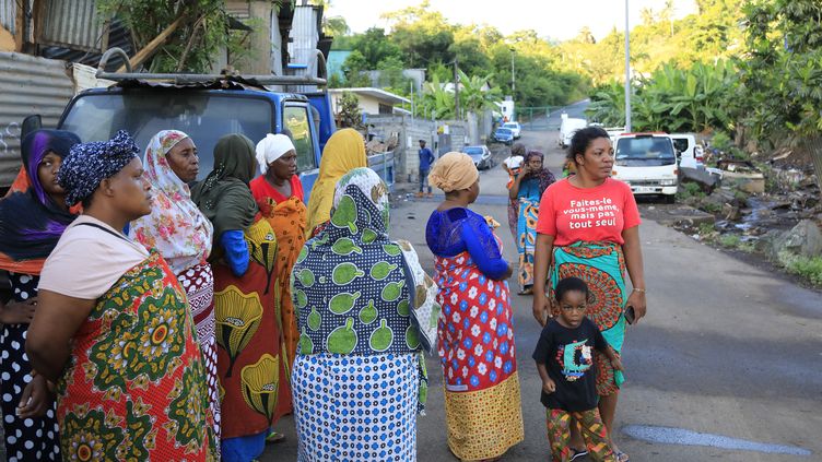 Women standing in front of the gendarmes, in the Majicavo district, in the commune of Koungou, on April 25, 2023. (CHAFION MADI / AFP)