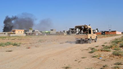 Un pick-up des combattants kurdes entre dans Yengice (Irak) le 8 septembre 2014, alors que les jihadistes de l'Etat islamique contr&ocirc;lent la r&eacute;gion. (ALI MUKARREM GARIP / ANADOLU AGENCY / AFP)