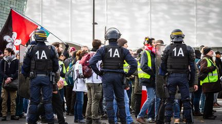 Des forces de l'ordre devant des manifestants, lors du 56e samedi de mobilisation des "gilets jaunes", le 7 décembre 2019 à Paris. (AMAURY CORNU / HANS LUCAS / AFP)