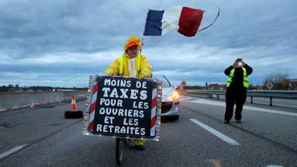 Ce "gilet jaune" qui occupe un rond-point à Roppenheim (Bas-Rhin), réclame "moins de taxes pour les ouvriers et les retraités", le 7 décembre 2018 (VINCENT KESSLER / REUTERS)