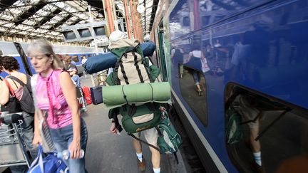 Des voyageurs portant des sacs à dos, gare de Lyon, en 2006, à Paris (photo d'illustration). (FRED DUFOUR / AFP)