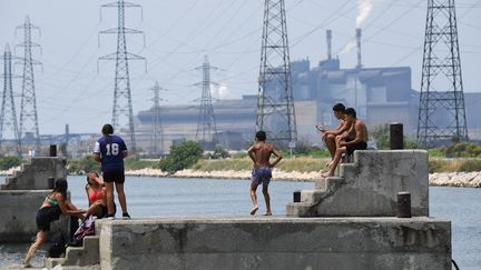 Des jeunes prennent le soleil, le 21 juin 2017, à Fos-sur-Mer (Bouches-du-Rhône). (ANNE-CHRISTINE POUJOULAT / AFP)