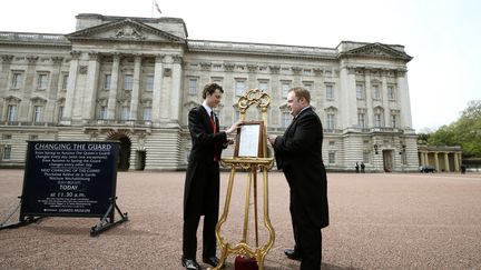 Des personnels de&nbsp;Buckingham Palace installent le bulletin royal annon&ccedil;ant la naissance de la fille de Kate Middleton et du price William, le 2 mai 2015. (  REUTERS)