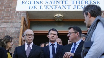 Le ministre de l'Int&eacute;rieur Bernard Cazeneuve et le Premier ministre Manuel Valls &agrave; la sortie de l'&eacute;glise Sainte-Th&eacute;r&egrave;se de Villejuif (Val-de-Marne), le 22 avril 2015. (KENZO TRIBOUILLARD / AFP)