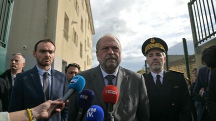 French Minister of Justice Eric Dupond-Moretti speaks to the press in front of the Caen-Ifs prison, near Caen, Calvados, on May 14, 2024, during a visit to meet colleagues of victims of the attack at the Incarville tollbooth.  (LOU BENOIST / AFP)