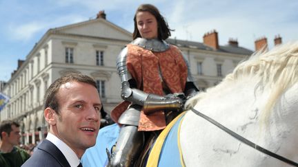 Emmanuel Macron, aux côtés de l'interprète de Jeanne d'Arc, lors des fêtes johanniques d'Orléans (Loiret), le 8 mai 2016.&nbsp; (GUILLAUME SOUVANT / AFP)