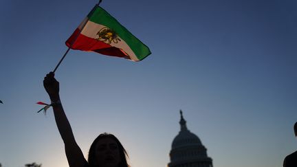 Le drapeau iranien brandi par une manifestante à Washington en octobre 2022. Image d'illustration. (STEFANI REYNOLDS / AFP)