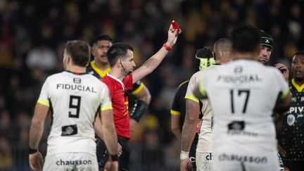 L'arbitre français Thomas Lavault sort le carton rouge, à l'occasion d'un match de Top 14 entre La Rochelle et le Stade toulousain, le 30 décembre 2023. (XAVIER LEOTY / AFP)