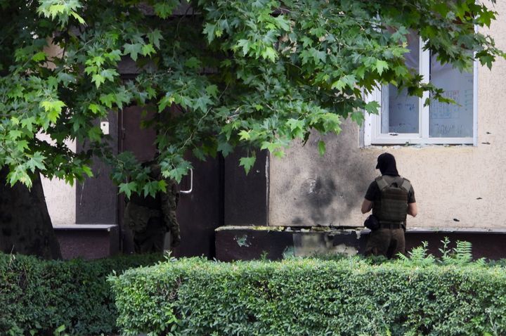 Investigators at the scene of an explosion near the local Interior Ministry on June 12, 2022 in Melitopol (Ukraine), a city occupied by Russian forces.  (ALEXEI KONOVALOV / TASS VIA SIPA)