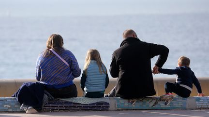 Un couple et ses deux enfants au bord d'une piste cyclable face à la rade de Marseille, le 15 janvier 2023. (VALLAURI NICOLAS / MAXPPP)