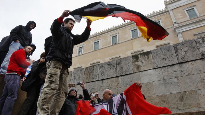 Des manifestants s'appr&ecirc;tent &agrave; br&ucirc;ler des drapeaux allemands et nazis devant le Parlement grec, &agrave; Ath&egrave;nes, le 7 f&eacute;vrier 2012.&nbsp; (ON)