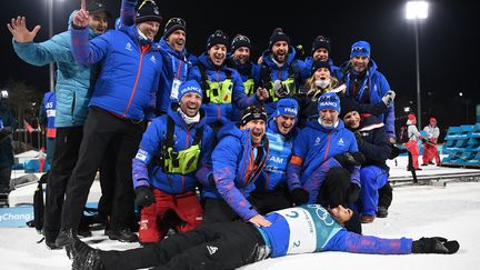 Martin Fourcade, entouré&nbsp;du staff de l'équipe de France de biathlon, savoure sa victoire sur la mass start (15 km) aux Jeux olympiques&nbsp;de&nbsp;Pyeongchang, le 18 février 2018. (FRANCK FIFE / AFP)