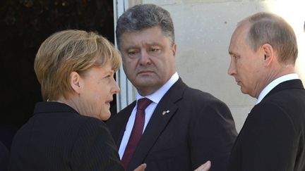  (Angela Merkel, Petro Porochenko et Vladimir Poutine avaient déjà évoqué le devenir de l'Ukraine lors du 70e anniversaire du Débarquement. © MaxPPP)