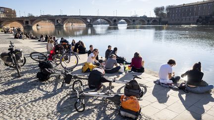 Le 1er janvier 2022, en plein hiver, des habitants de Toulouse (Haute-Garonne) sur les bords de la Garonne. (FRANCOIS LAURENS / HANS LUCAS)