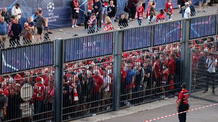 Les supporters de Liverpool attendent à l'extérieur du Stade de France, le soir de&nbsp;la finale de la Ligue des champions, le 28 mai 2022 à Saint-Denis (Seine-Saint-Denis). (THOMAS COEX / AFP)