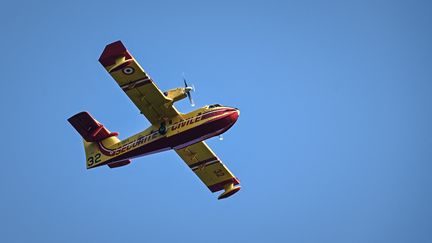 Un bombardier d'eau intervient sur un feu de forêt près de Le Tuzan, en Gironde, le 27 juillet 2020. (PHILIPPE LOPEZ / AFP)