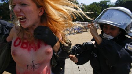 Des policiers allemands arr&ecirc;tent une militante des Femen pr&egrave;s du Tiergarten &agrave; Berlin (Allemagne) en marge de la visite du pr&eacute;sident am&eacute;ricain, Barack Obama, le 19 juin 2013. (PAWEL KOPCZYNSKI / REUTERS)