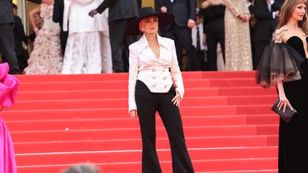 Chapeau noir sur chemise blanche, l'actrice française Emmanuelle Béart heureuse de monter les premières marches de la 76e édition. (VITTORIO ZUNINO CELOTTO / GETTY IMAGES EUROPE)