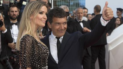 L'acteur Antonio Banderas, accompagné de sa femme&nbsp;Nicole Kimpel, lève le pouce durant la montée des marches de&nbsp;Douleur et Gloire. Le film de Pedro Almodovar permettra à l'acteur espagnol de remporter le Prix d'interprétation masculine. (BOESL / DPA)