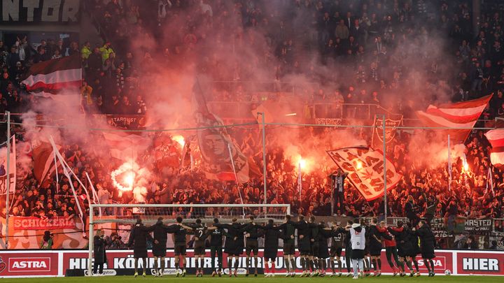 FC Sankt Pauli players and fans celebrate victory against Hansa Rostock on April 26, 2024 at Millerntor Stadion in Hamburg, Germany. (AFP)