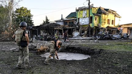 Rescue workers respond after airstrikes in the southern Ukrainian city of Vilnyansk on June 29, 2024. (DMYTRO SMOLIENKO / NURPHOTO / AFP)