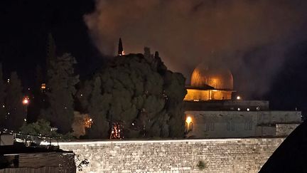 Une image issue d'une vidéo d'AFPTV, montrant un arbre en feu à l'Esplanade des Mosquées, à Jérusalem, le 10 mai 2021.&nbsp; (CLAIRE GOUNON / AFP)