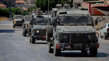 Israeli army armored vehicles in the occupied West Bank on August 14, 2024. (WAHAJ BANI MOUFLEH / AFP)