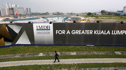 Un homme passe devant un panneau publicitaire où s'affichent les ambitions du fonds d'investissement 1 Malaysia Development Berhad (1MDB) à Kuala Lumpur (Malaisie) le 1er mars 2015.  (REUTERS/Olivia Harris )