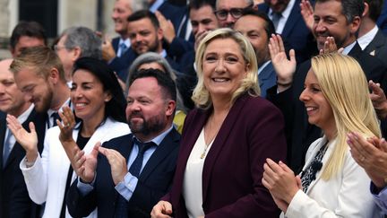 Marine Le Pen a pris la pose, le 22 juin 2022, comme les 88 autres députés RN, devant l'Assemblée nationale, à Paris. (ALAIN JOCARD / AFP)