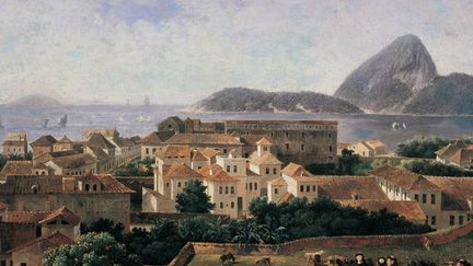 Nicolas Antoine Taunay peint Rio, reconnaissable au pain de sucre. Mais, curieusement, la ville ressemble à une cité italienne. Felix Emile Taunay vient d&#039;arriver sur place, il rêve encore le Brésil plus qu&#039;il ne le montre .
	 
 (DR)