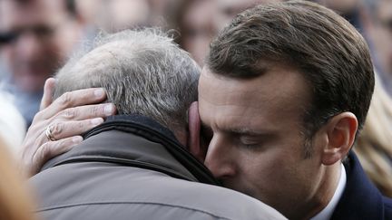 Le président de la République, Emmanuel Macron, réconforte les familles des victimes lors de la cérémonie d'hommage aux victimes des attentats du 13 novembre 2015, le 13 novembre 2017 à Paris.&nbsp; (ETIENNE LAURENT / AFP)