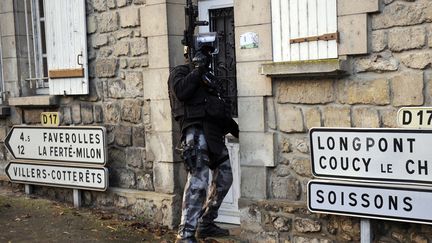 Members of the French police special force GIPN opens a door in Corcy, northern France, on January 8, 2015 during searches as part of an investigation into a deadly attack the day before by armed gunmen on the Paris offices of French satirical weekly Charlie Hebdo. (FRANCOIS LO PRESTI / AFP)