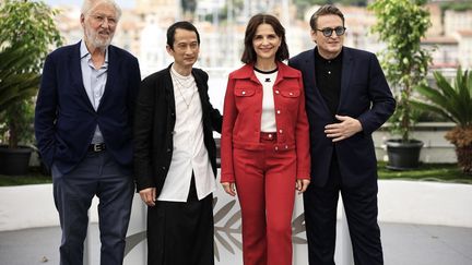 French chef Pierre Gagnaire, French-Vietnamese director Tran Anh Hung, French actress Juliette Binoche and French actor Benoit Magimel during the photocall for the film "The Passion of Dodin Bouffant"during the 76th edition of the Cannes Film Festival, May 25, 2023. (VALERY HACHE / AFP)