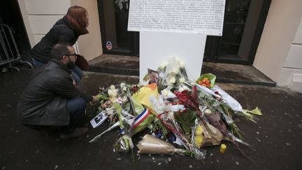 Des fleurs déposées devant le Bataclan à Paris, le 13 novembre 2016, un an après la tuerie qui a fait 90 morts.&nbsp; (JOEL SAGET / AFP)