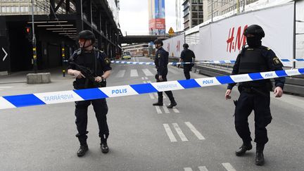 Des policiers dressent un cordon de sécurité autour du lieu où un camion s'est encastré dans un magasin, le 7 avril 2017, dans le centre-ville de Stockholm (Suède). (JONATHAN NACKSTRAND / AFP)