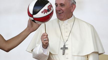 Le pape Fran&ccedil;ois s'amuse avec un ballon de basket offert par un joueur sur la place Saint-Pierre au Vatican, le 7 juin 2014. (MAX ROSSI / REUTERS)