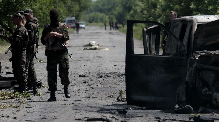 Des soldats ukrainiens inspectent le site d'une attaque s&eacute;paratiste pr&egrave;s du village de Blahodatne, dans l'est de l'Ukraine, le&nbsp;22 mai 2014. (IVAN SEKRETAREV / AP/ SIPA)