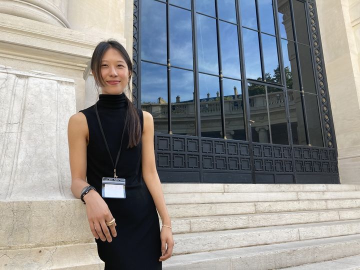 L’artiste Yoon Sunwoo devant le Palais Galliera à Paris, le 5 octobre 2023. A sa main droite, elle porte l'un des bijoux réalisé pour la performance "Le Pari" dans le cadre du festival Parcours Bijoux. (Corinne Jeammet)