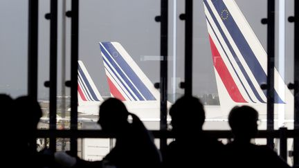 Des passagers patientent avant d'embarquer dans un avion de la compagnie Air France, le 15 septembre 2014, &agrave; l'&eacute;roport d'Orly.&nbsp; (KENZO TRIBOUILLARD / AFP)