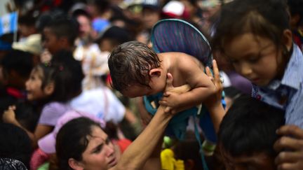 Les réfugiés sont parfois accompagnés de bébés âgés de quelques semaines seulement. On le voit sur ce cliché, pris le 19 octobre 2018 à la frontière reliant Ciudad Tecun Uman (Guatemala) à Ciudad Hidalgo (Mexique). (PEDRO PARDO / AFP)