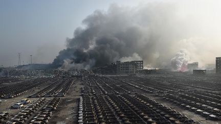 Nuages de fum&eacute;e au-dessus des explosions en cha&icirc;ne qui ont ravag&eacute; une zone industrielle de Tianjin. La deuxi&egrave;me d&eacute;flagration affichait une puissance &eacute;quivalente &agrave; la d&eacute;tonation de 21 tonnes de TNT selon des relev&eacute;s sismographiques. (GREG BAKER / AFP)