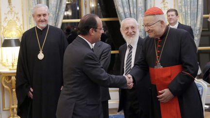 Fran&ccedil;ois Hollande serre la main du cardinal Andr&eacute; Vingt-Trois, archev&ecirc;que de Paris,&nbsp;lors de la c&eacute;r&eacute;monie des v&oelig;ux pr&eacute;sidentiels, &agrave; l'Elys&eacute;e, le 7 janvier 2014.&nbsp; (CHRISTOPHE ENA / AFP)