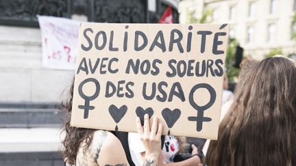 Une pancarte tenue lors d'un rassemblement organisé Place de la&nbsp;République à Paris,&nbsp;en soutien aux femmes américaines, le 24 juin 2022. (FIORA GARENZI / HANS LUCAS / AFP)