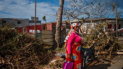 Une femme marchant à Pamandzi, à Mayotte, le 17 décembre 2024, au milieu d'un paysage dévasté par le cyclone Chido. (DIMITAR DILKOFF / AFP)