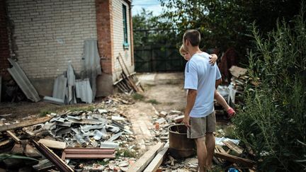 &nbsp; (Deux Ukrainiens regardent les débris de leur maison, près de Slaviansk, dans l'Est de l'Ukraine © MaxPPP /)