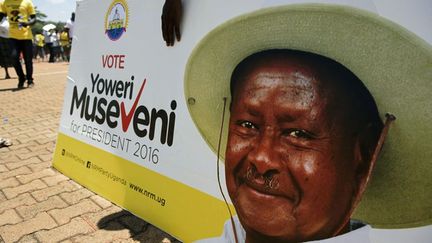 Partisan de Yoweri Museveni tenant son portait pendant la campagne électorale à Kampala, le 16 février 2016. (Photo AFP/Isaac Kasamani)