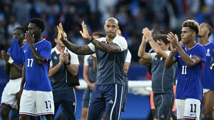 Thierry Henry and the players of the French Olympic football team greet the crowd at the Parc des Princes after their defeat in the final of the Paris 2024 tournament on August 9. (JONATHAN NACKSTRAND / AFP)