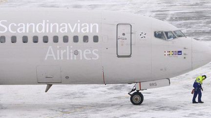 12 décembre 2012. Un Boeing 737 de la compagnie SAS, détenue à 50% par le Danemark, la Suède et la Norvège, sur la piste de l'aéroport Arlanda, à Stockholm (Suède).

	  ( REUTERS/Johan Nilsson/Scanpix)