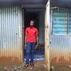 Saïd Abdul Karim devant sa maison de tôle, dans le bidonville de Kawéni, à Mayotte, le 18 avril 2023. (ROBIN PRUDENT / FRANCEINFO)